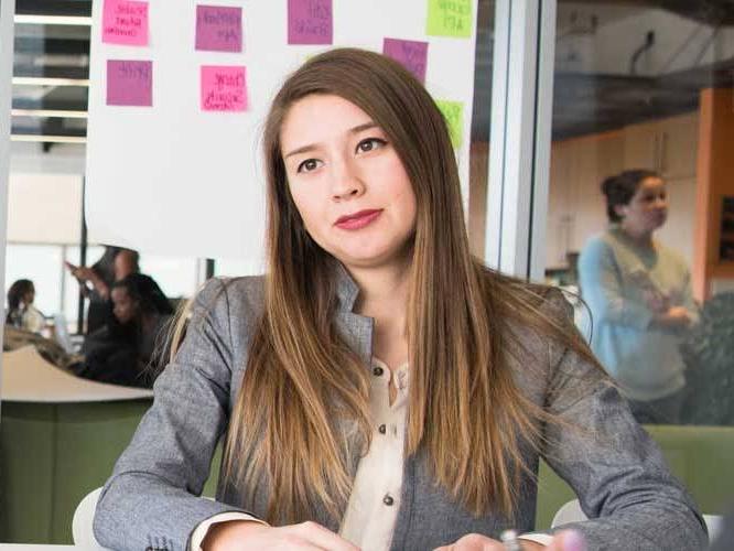 Business woman sitting down smiling for a picture